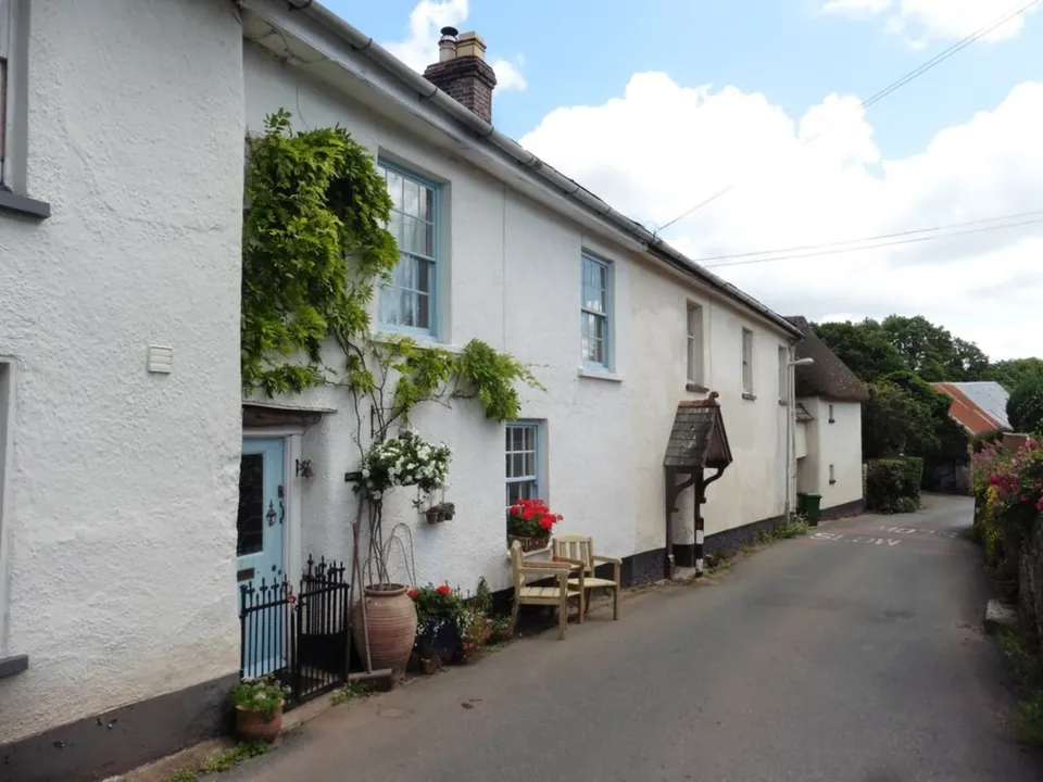 Traditional cottages lining a narrow road in Coleford, Devon